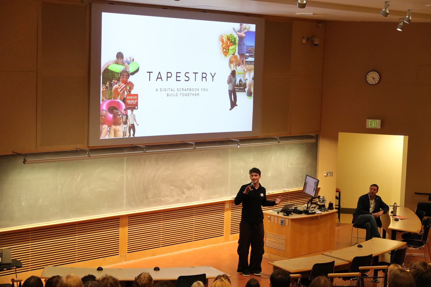 Luke Hattrup presenting Tapestry on stage in a lecture hall